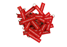 Load image into Gallery viewer, &quot;REMOVE BEFORE INSPECTION&quot; KEYCHAIN
